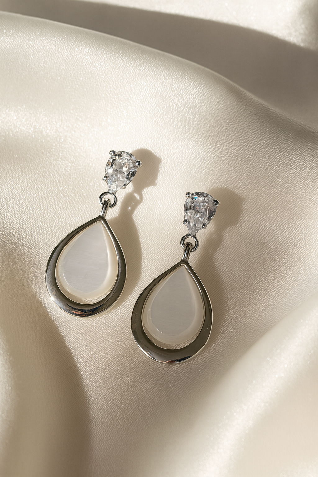 Jewello fashionable silver plated and oval shape white stone stud anti tarnish dangle Korean earring for women and girls.