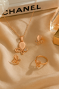 Jewello trendy rose gold plated floral design with white stone stud chain pendant set for women and girls.