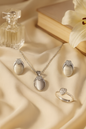 Jewello stylish silver-plated oval shape design with white stone stud chain pendant set for women and girls.