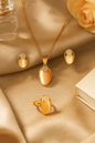 Jewello trendy gold-plated oval shape design with white stone stud chain pendant set for women and girls.