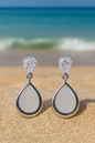 Jewello fashionable silver plated and oval shape white stone stud anti tarnish dangle Korean earring for women and girls. Gift for her.
